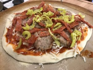 homemade pizza with meatballs, peperoncin, pepperoni